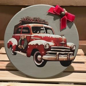 Handcrafted Christmas red truck on wood disc